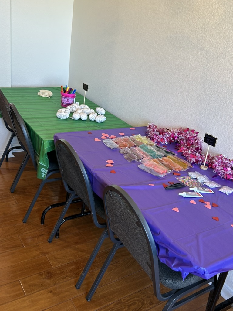 Craft tables set up with glasses decorating supplies and football wraps