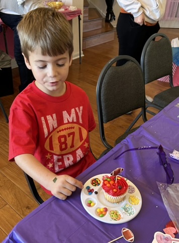 Guest admiring his fully decorated cupcake with candy toppings