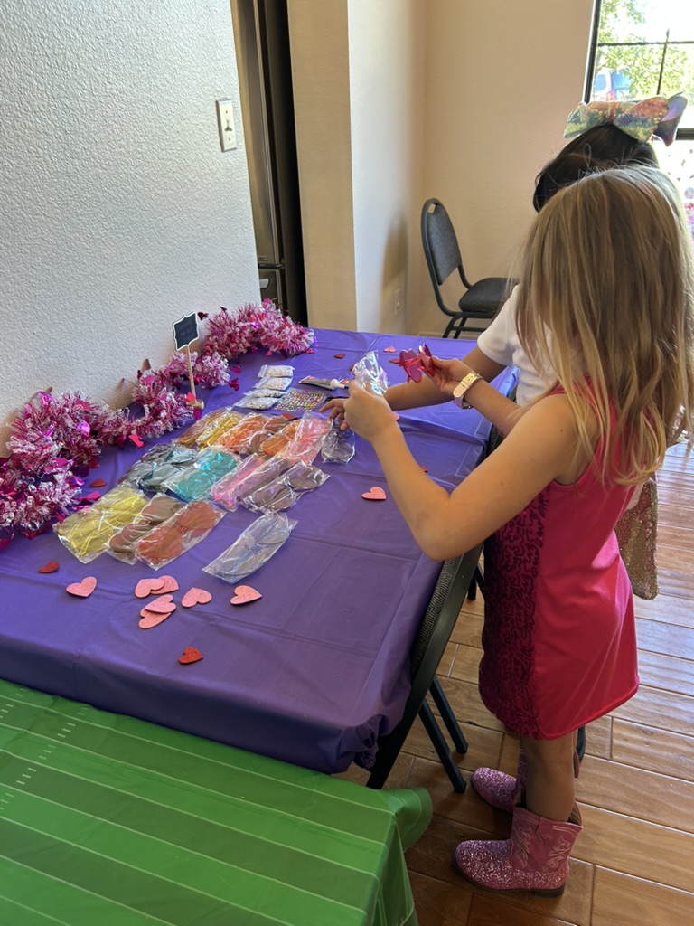 Guest decorating sunglasses at the craft table